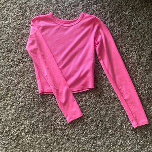 A neon pink long sleeve crop top
